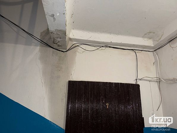 Следы влаги на стенах и потолке и проложенные провода в подъезде дома на улице Алексея Резниченко